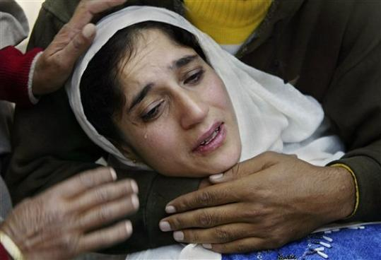 Gulshan Javed, wife of detained Kashmiri man Javed Ahmad Dar, cries during a protest against Dar's detention by Indian occupation soldiers in Srinagar, India, Saturday, Oct. 25, 2008